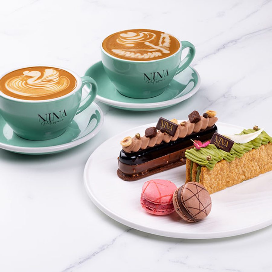 Two coffees and a plate of cakes at Nina Patisserie